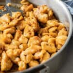 Fully cooked chicken bites in a saute pan.