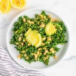 Kale White Bean Salad on a white platter with avocado slices