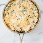 baked spinach artichoke dip in skillet before baking