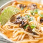 close up of Thai coconut soup in a white bowl