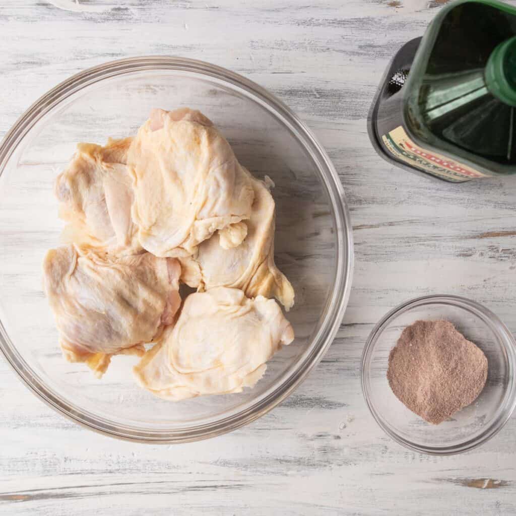 chicken thighs and seasonings on a table