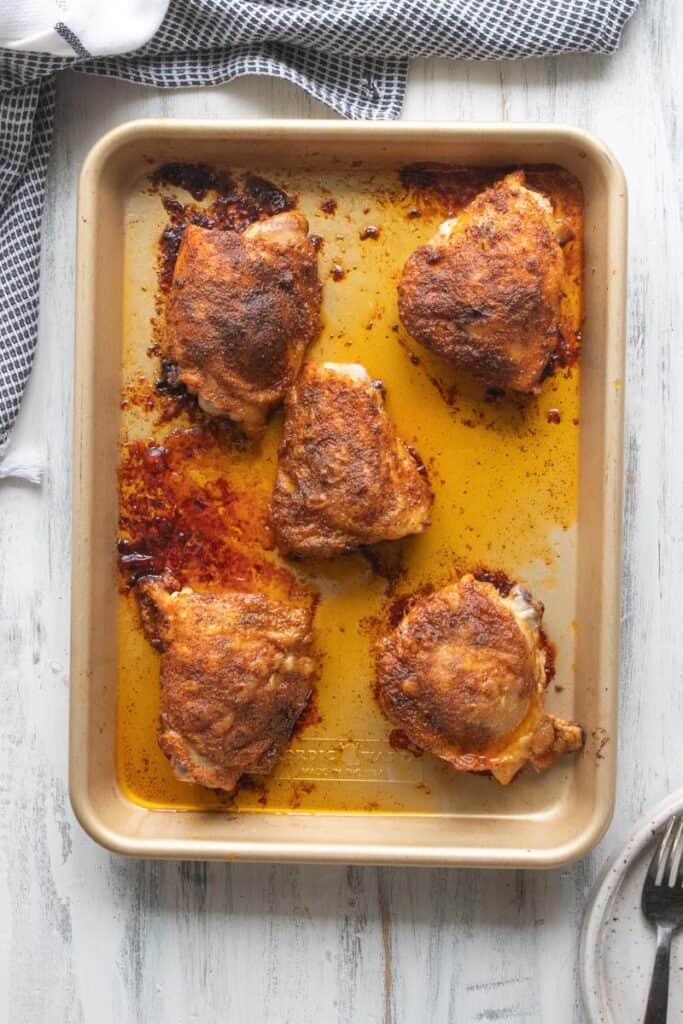 crispy chicken thighs on a baking sheet