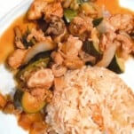 stir fry next to rice on a plate