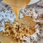 popcorn with Salted Caramel topping being added in a bowl