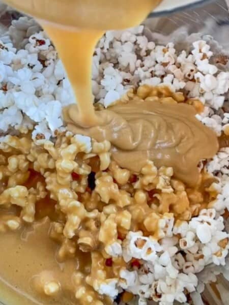 popcorn with Salted Caramel topping being added in a bowl