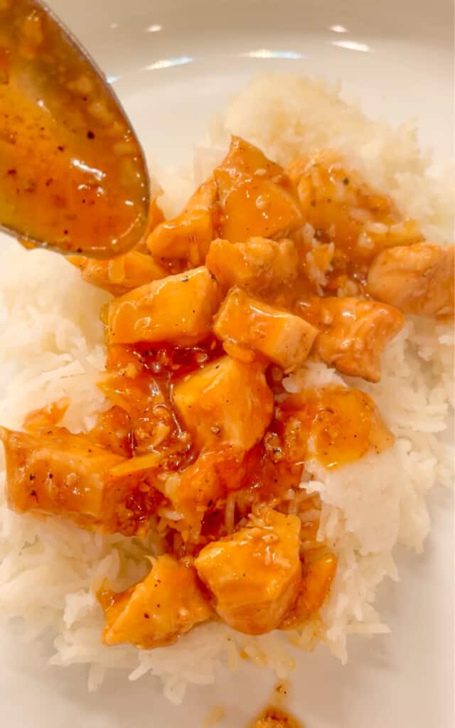 Orange Sesame Chicken with sauce being added